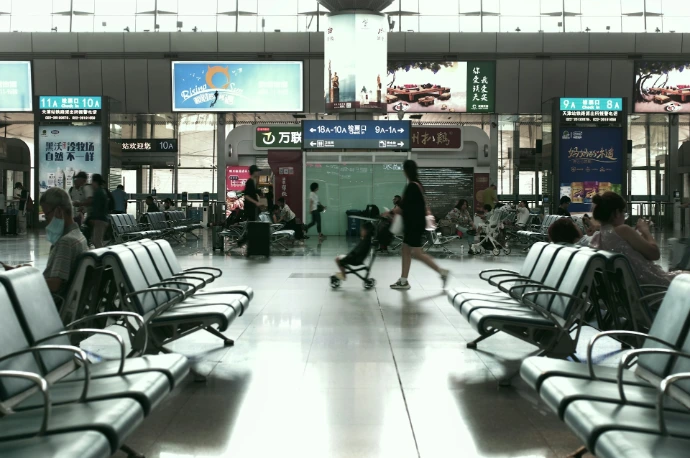 A group of people walking through an airport